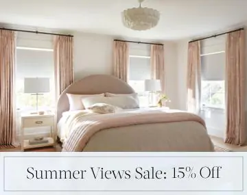 Blackout Drapery & Roller Shades darken a pink and white bedroom with sales messaging for Summer Views Sale: 15% Off