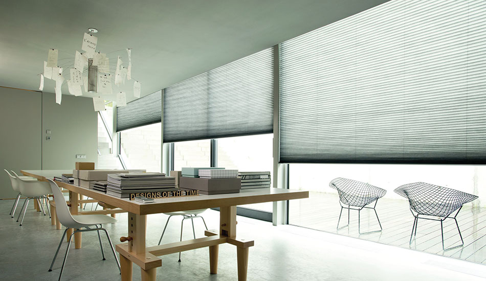 Light filtering cellular shades for sliding glass doors add light control to a modern conference room