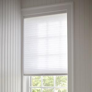 A bathroom window feature a Cellular Shade made of 3-4 Caluna Light Filtering material in White for privacy