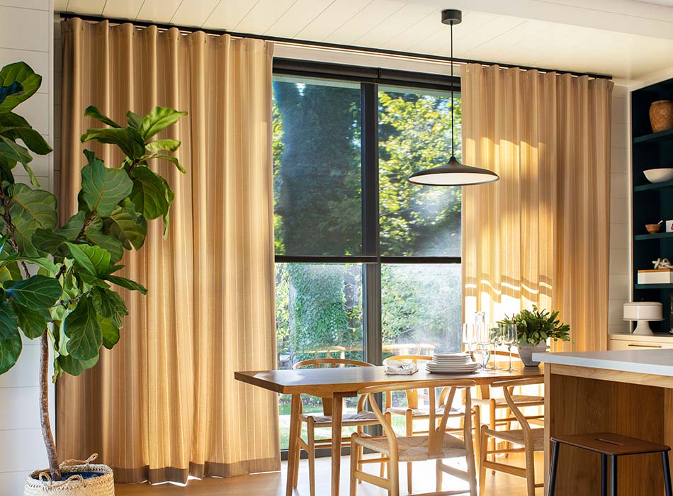 Sliding glass door curtain ideas include Cubicle Drapery made of Dashing Stripe in Palomino for a bright sunny dining room
