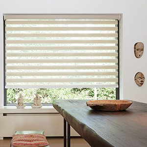 A Double Roller Shade made of Windansea in Canyon adds clean lines to a rustic dining room with natural elements