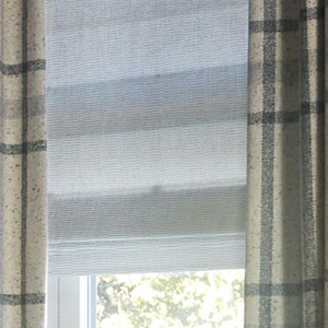 Flat Roman Shades made of Dakota in White without any lining allow light to filter through for a soft, warm glow