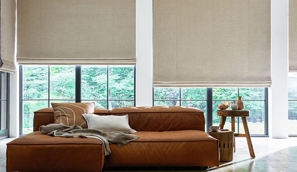 Roman Shades for sliding glass doors made of Herringbone in Toast add warm color and texture to a living room