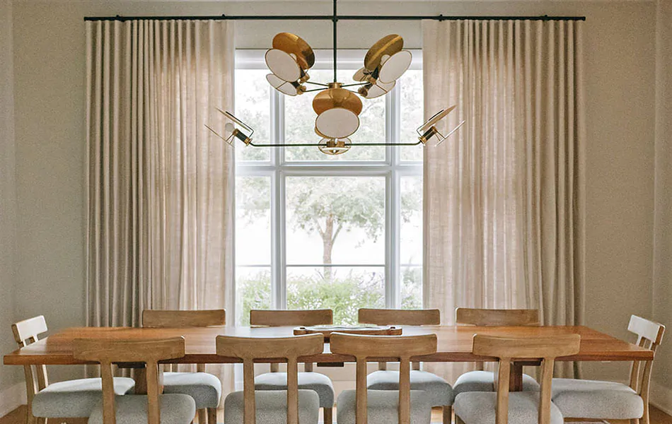 Dining room curtain ideas like Luxe Linen drapes in Beige complement the light wood dining table