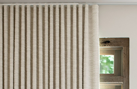 Ripple Fold Drapery made of Claude Stripe in Alabaster on a track system is a great choice for home office curtains