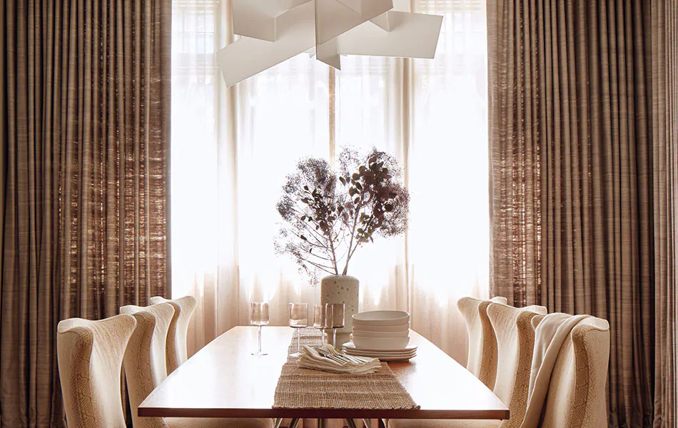 Dining room curtain ideas like layered Raw Silk drapes with Luxe Sheer Linen create a modern, elegant space