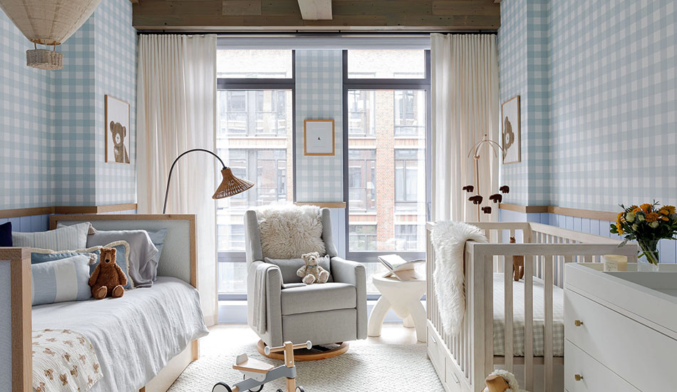 A nursery with blue and warm white colors has Ripple Fold neutral curtains made of Sheer Wool Blend in Cloud for a soft look