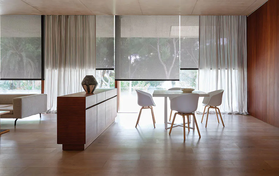 Dining room curtain ideas like sheer drapes layered with Solar Shades give you lots of light filtration