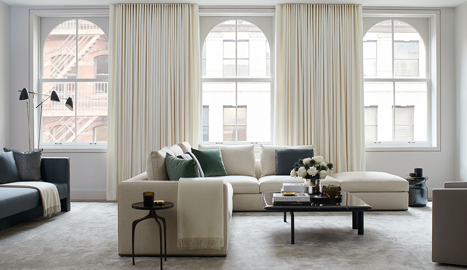 Neutral curtains made of Wool Flannel in Glacier add warmth with their color and soft texture to a modern living room