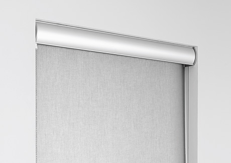 A product image of Roller Shades for windows shows a silver metal valance that covers the tube at the top of the window