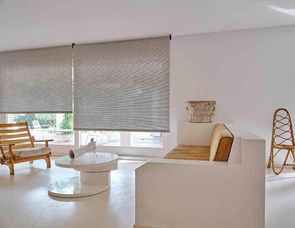 A mid-century modern space with white and wood tones has sliding doors with Roller Shades made of Mesa Verde in Mist