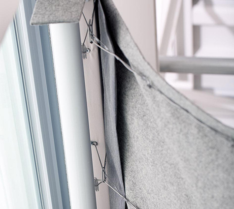 The tension device for cordless Roman Shades is a tube seen in the headrail that controls the height of your shade