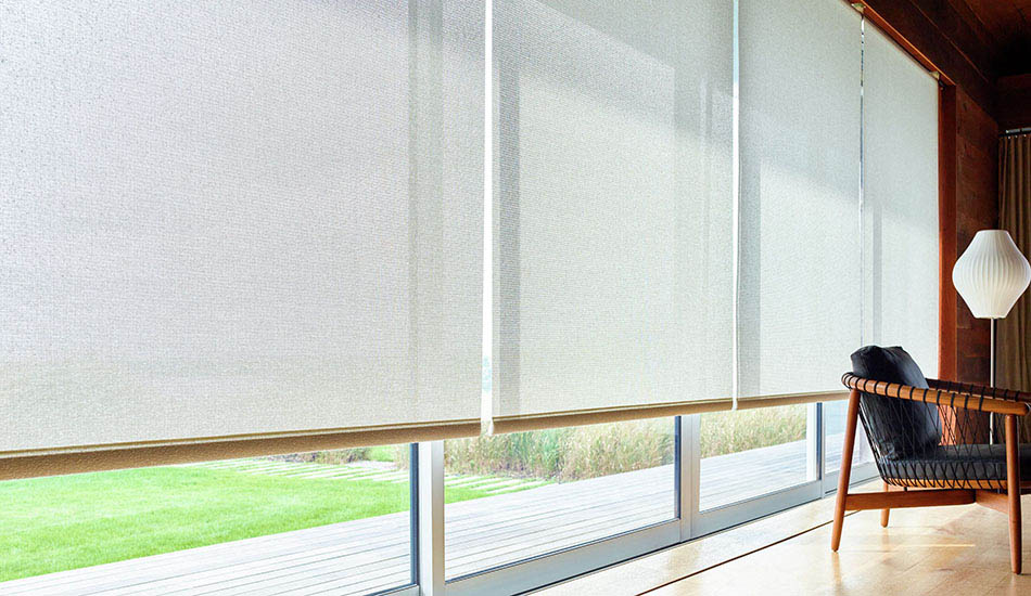 Solar Shades for sliding glass doors hang low to block the sunlight in a mid-century modern home