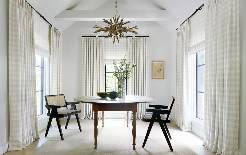Dining room curtain ideas like layered Roman Shades and Drapes both in Emerson in Shea create inviting layers