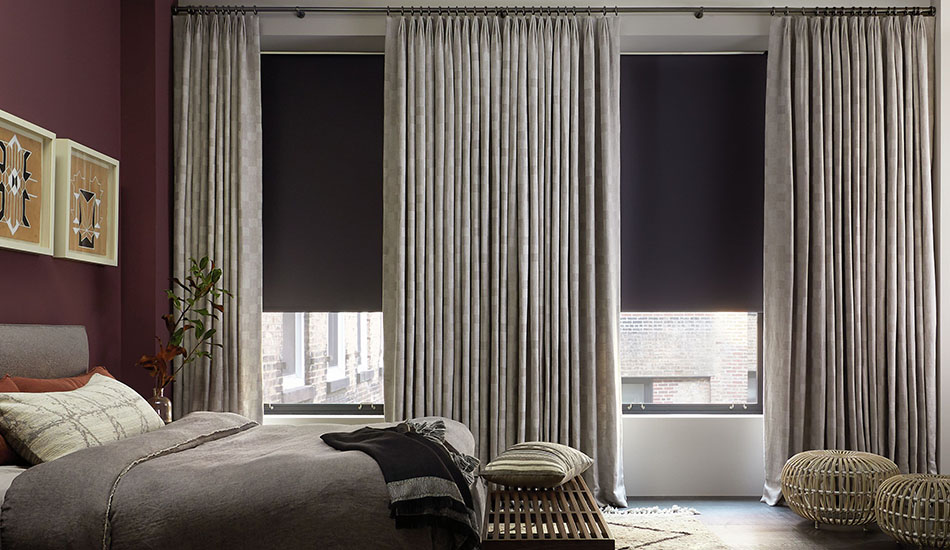 Modern bedroom window treatment ideas include Tailored Pleat Drapery in Oceana, Stone and Roller Shades in Bond, Charcoal