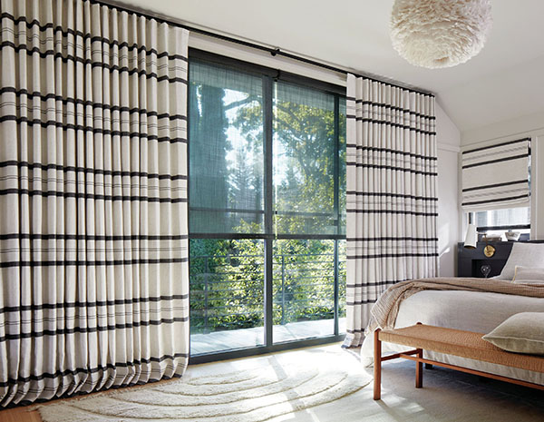 Ripple Fold Drapery made of Shoreham Stripe in Jet adds a bold look to a modern bedroom with its black and white pattern