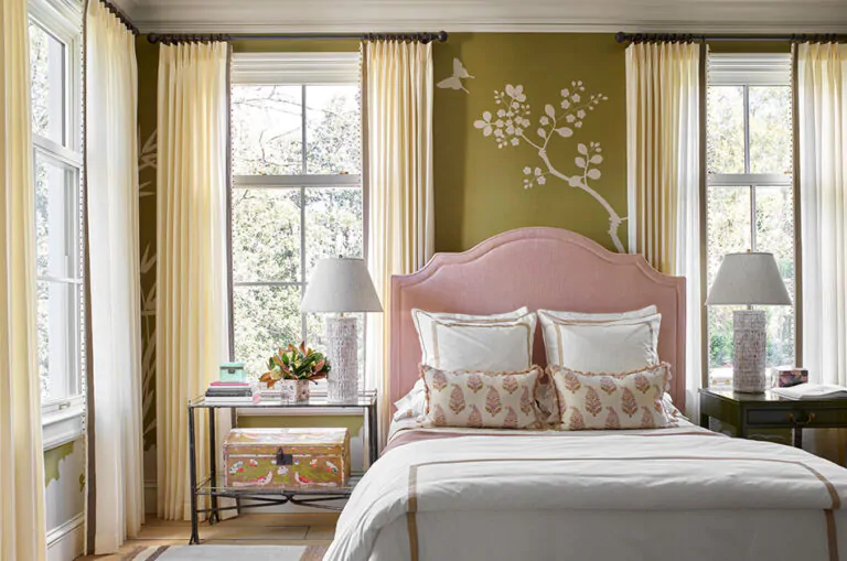 Bedroom window treatment ideas include tailored pleat drapery of Vitela, Ivory in an olive green bedroom with flower wallpaper