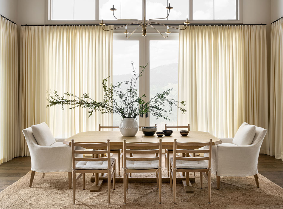 Sliding glass door curtain ideas include Tailored Pleat Drapery made of Wool Blend in Snow in a luxe dining room
