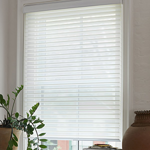 A close up image of a Venetian Roller Shade shows the s-curves of the Seaside material in White