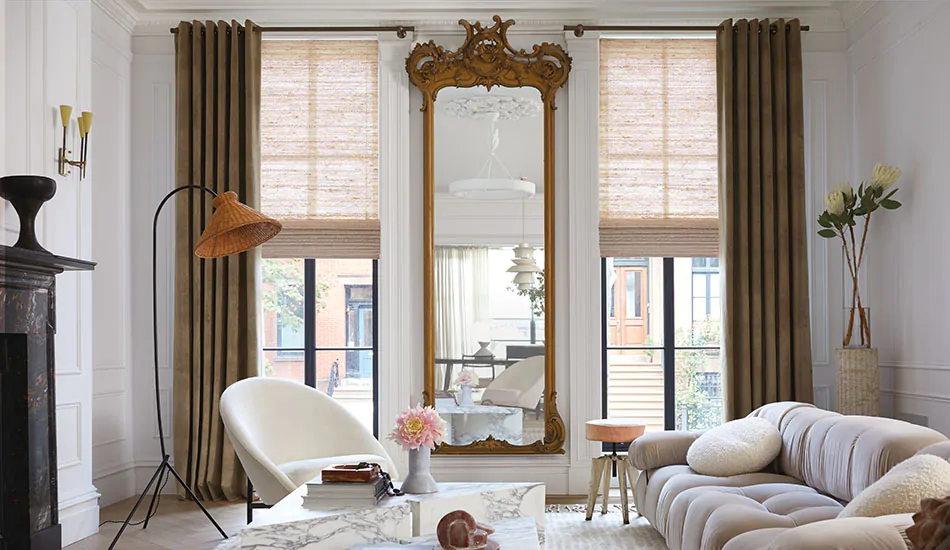 A stylish room features tall windows with Grommet Drapery made of Velvet in Camel for a dramatic effect
