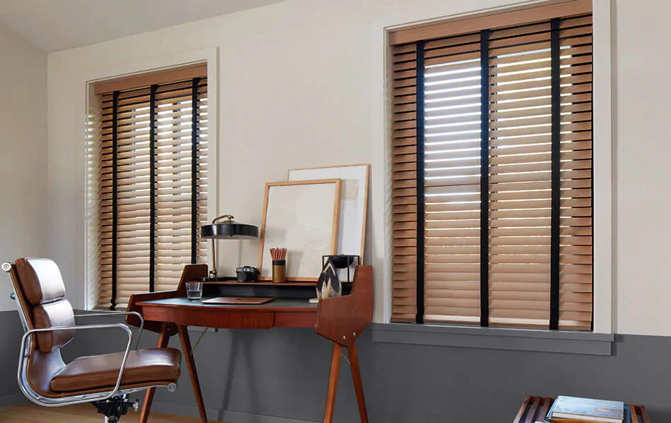 A mid-century modern office has Wood Blinds made of 2-inch Exotic in Oak with Noir decorative tape for a sophisticated look